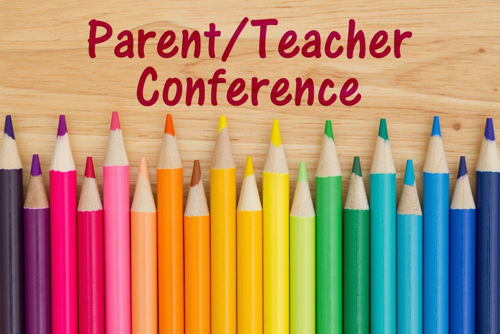 Colored pencils with  the words parent/teacher conferences on it. 